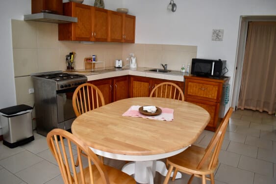 modern kitchen with dining area, stove, oven and microwave